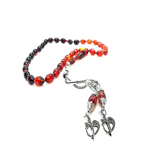 Close-up of 2023 spiritual beads made of natural wood and gemstones arranged in a circular pattern with a tassel hanging at the end.